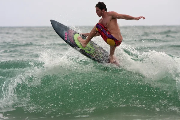 Male Surfer Rides Top Of Wave Off Florida Coastline