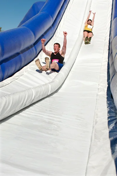 Couple Goes Down Giant Slide In Obstacle Race Challenge