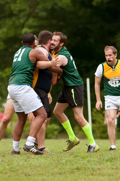 Player Gets Tackled In Amateur Game Of Australian Rules Football
