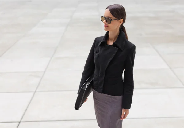 Beautiful young business woman in black jacket