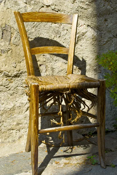 Old broken chair near the house of the town on the mountain hill called Gandria, Switzerland