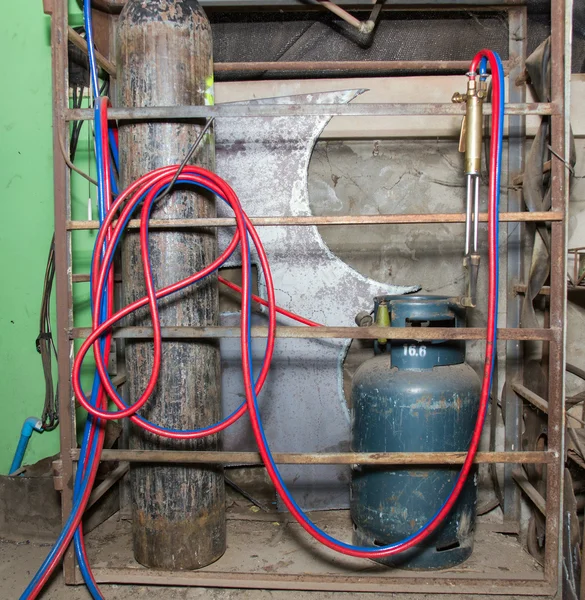 Gas and oxygen steell tank with Cutting torches in garage
