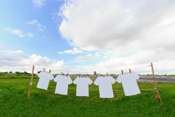 Shirts on a laundry line and blue sky.