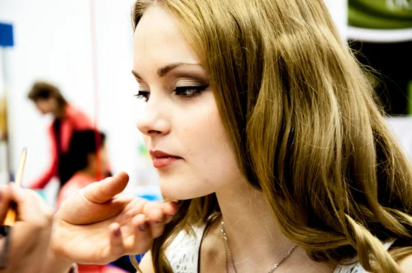 Makeup artist bring girl make-up