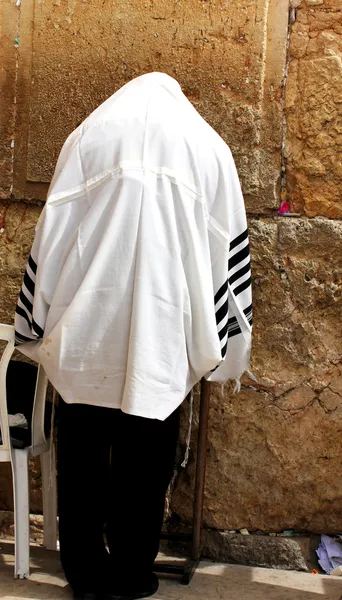 Unidentified man in tefillin praying at the Wailing wall (Western wall)