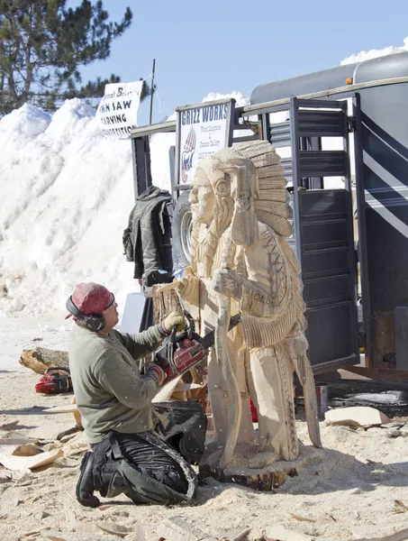Man Carving Indian Chief with Chainsaw