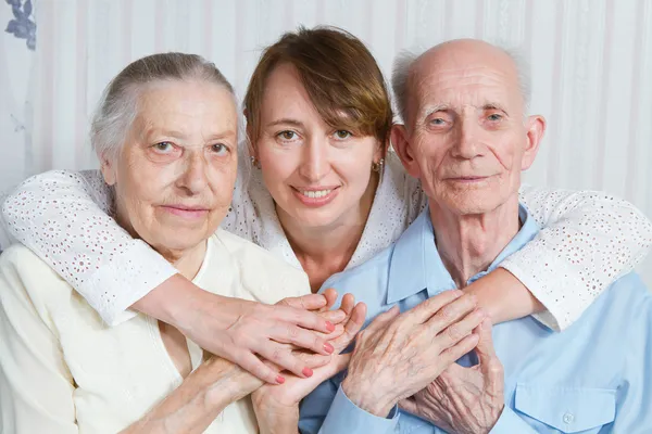 Senior Man, Woman with their Caregiver at Home.