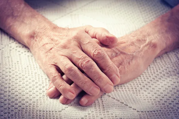 Old people holding hands.