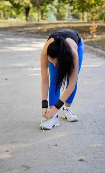 Woman athlete tying her shoelaces