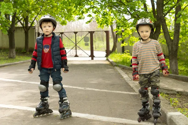 Two small boys kitted out for roller skating