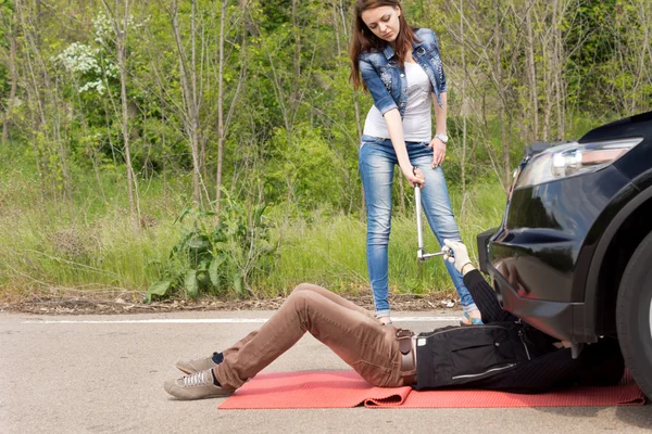 Mechanic and female driver at a roadside breakdown
