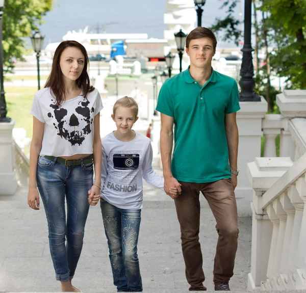 Attractive couple walking with a cute little girl