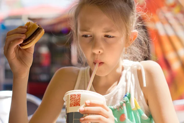 Girl drinking a cold beverage from a soda cup