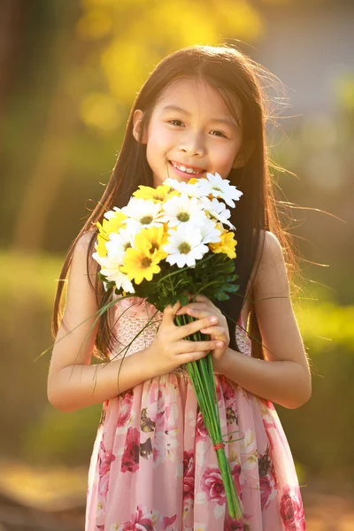 Smiling asian girl hold flowers
