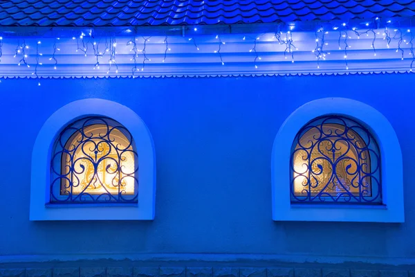 Christmas lighting with windows of the house