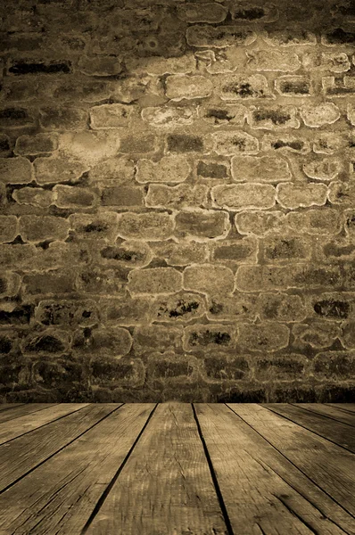 Old brick wall with wooden floor