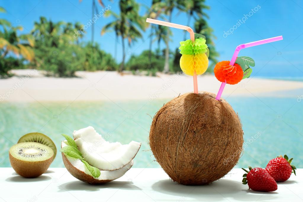 Fruit cocktails coconut on the beach — Stock Photo © denio109 23466712