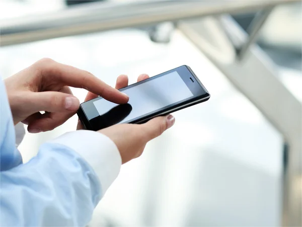 Close up of a business woman using mobile smart phone