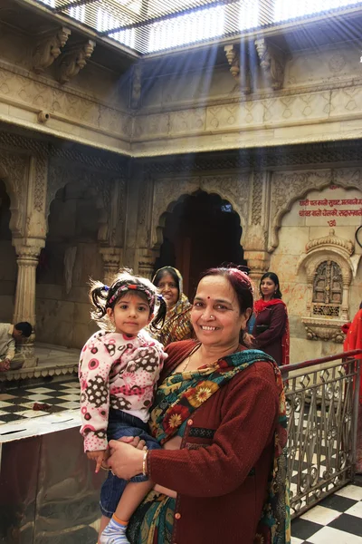 Indian woman with a girl standing inside of Karni Mata Temple, D