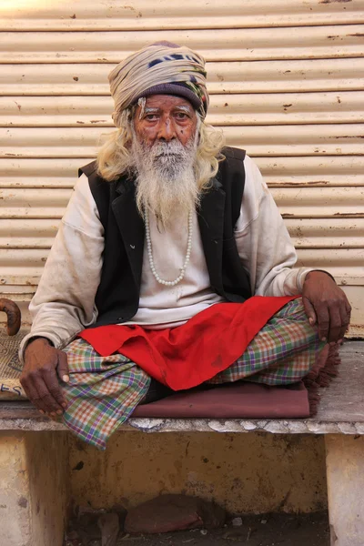 Indian man sitting in the street of Pushkar, India