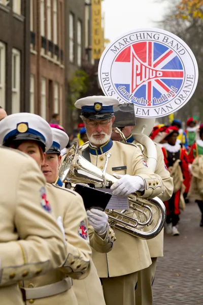 Marching band dressed in uniform playing music in a parade