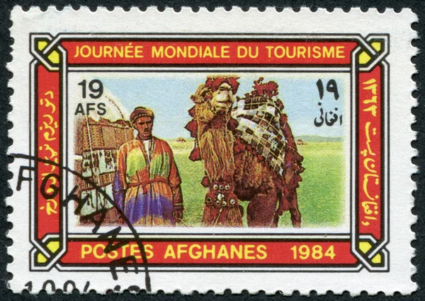 A stamp printed in the Afghanistan devoted to World Tourism Day. Depicted Camel driver, tent, camel in caparison, circa 1984