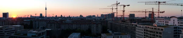 Sunrise over Berlin. Panorama. In the background the World Trade Center, buildings and cranes and hotel Park Inn by Radisson