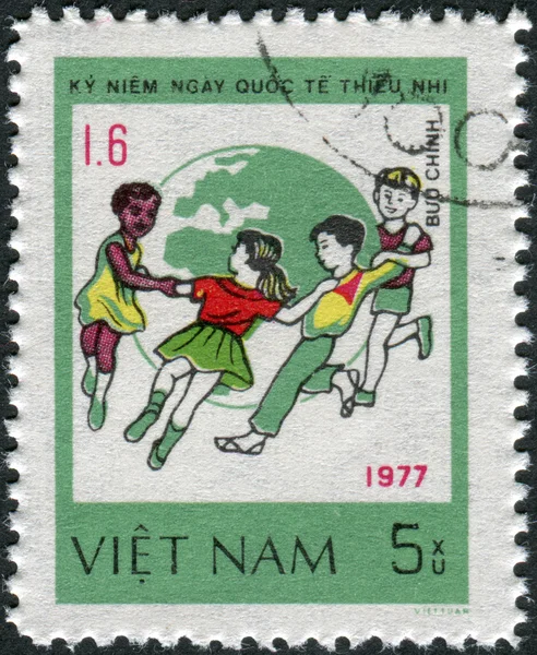 Postage stamp printed in Vietnam, dedicated to International Children's Day (1977), shows Children dance around Globe