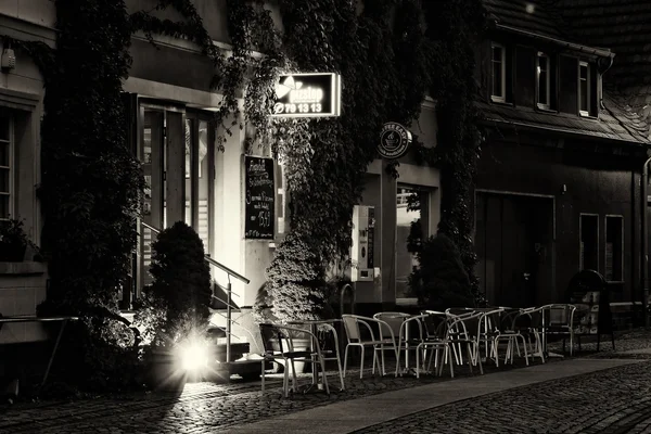 Evening cafe in the old town. The ancient city of Senftenberg. First mentioned in chronicles in 1276. Black and white. Styling. Large grains