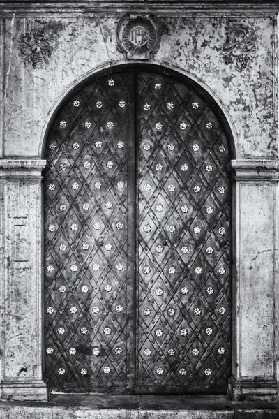 Ancient gate in the historic center of Prague. Black and white. Stylized film