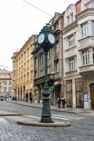 The streets of old Prague. The town clock on the pole. Crossroads.