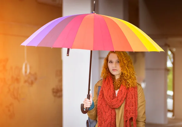 Redhead girl with umbrella.