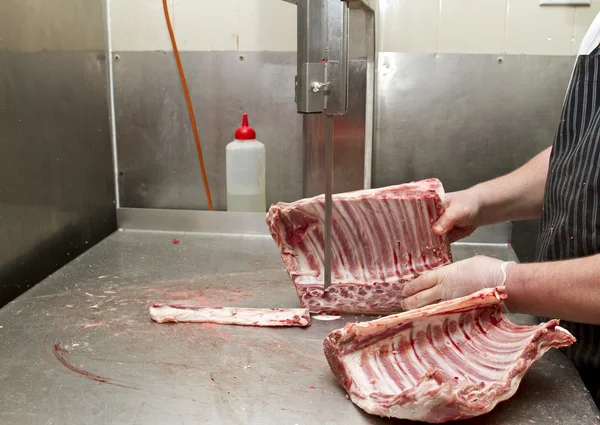 Butcher cutting meat
