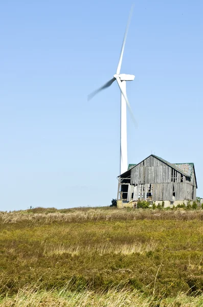 Power Generating Windmill Beside a Old Barn