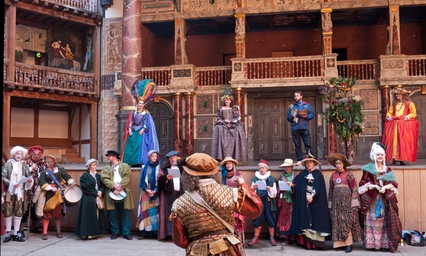 Performers in traditional costume in Shakespeare\'s Globe Theatre