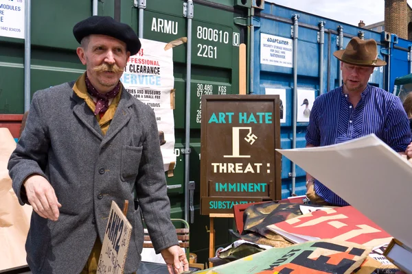 LONDON, UK-JUNE 19: International artist and cult figure, Billy Childish, selling work at the Annual Art Car Boot Fair in London\'s East End on June 19, 2011 in London UK