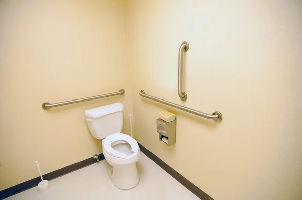Ada clean public toilet with grab bars for handicapped