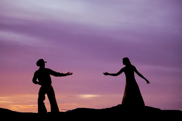 Cowboy reach for woman silhouette