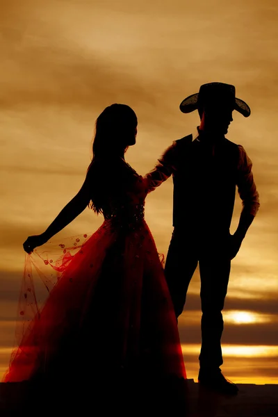 Silhouette cowboy and woman in dress