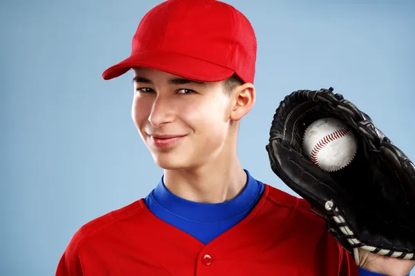 Portrait of a beautiful teen baseball player in red and white un