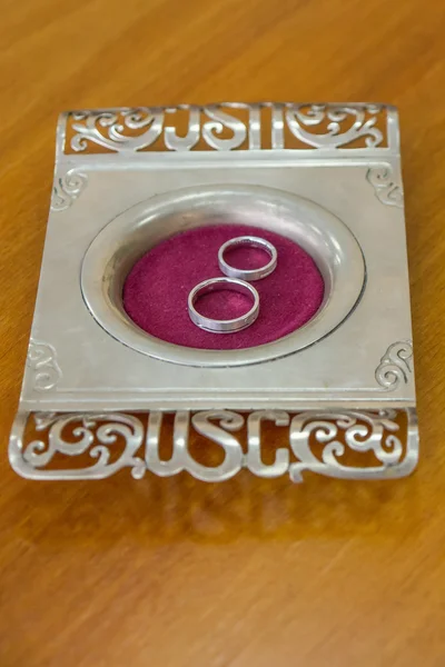 Two silver wedding rings on tray in Registry Office