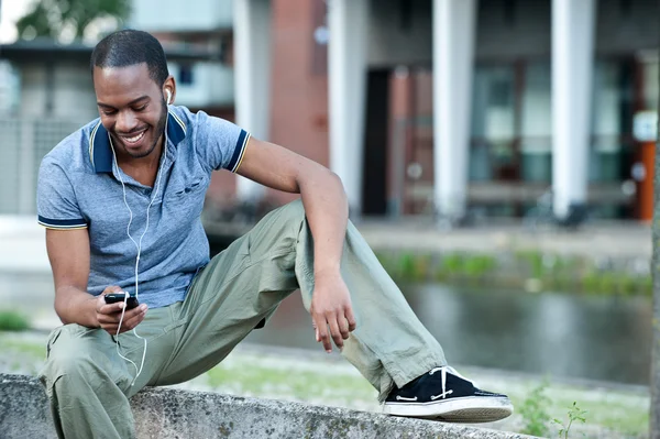 Young guy smiling to music