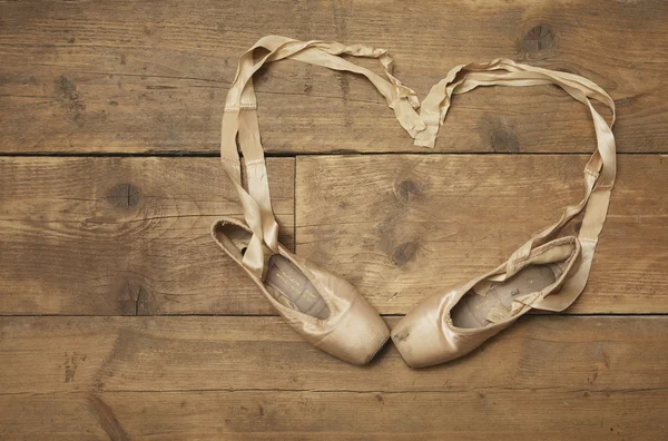 Two Ballet Shoes on Wooden Floor