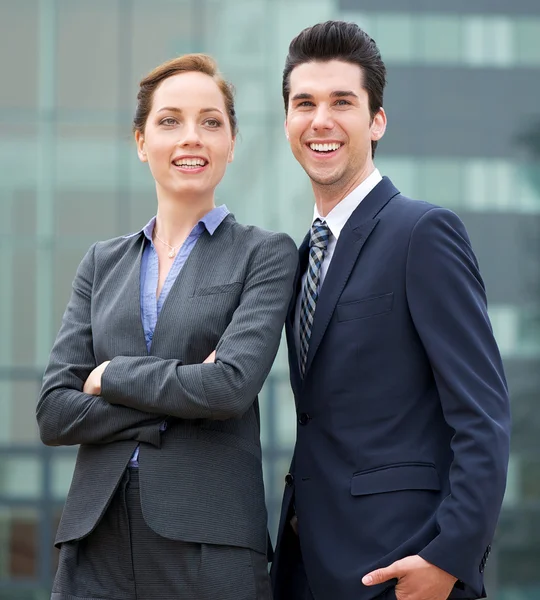 Relaxed businessman and business woman smiling