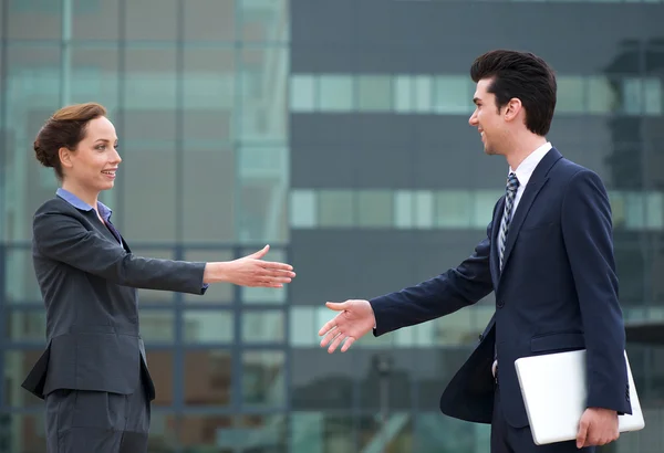 Businessman and business woman meeting with a handshake