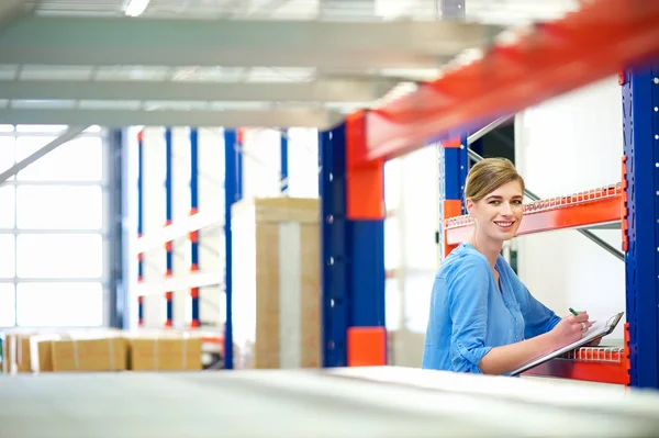 Businesswoman controlling inventory in a warehouse