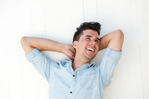 Happy young man laughing outdoors