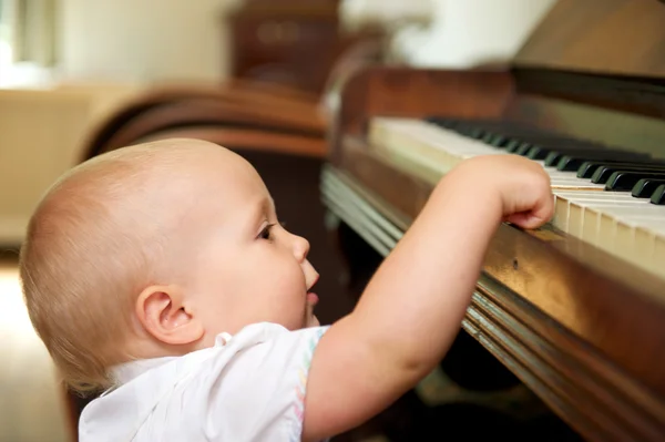 Cute baby playing on piano