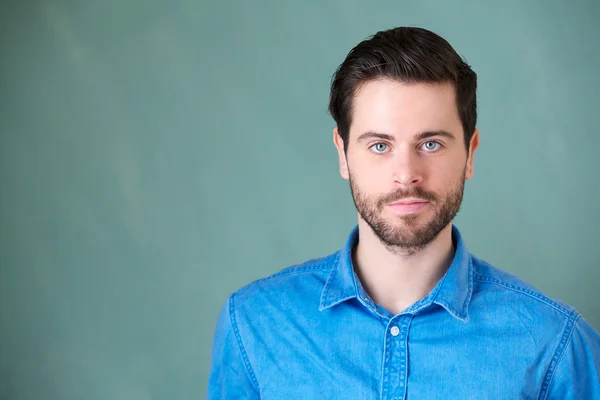 Attractive young man with beard looking at camera