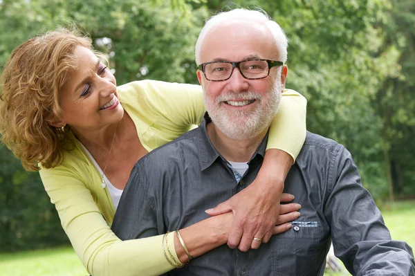 Happy senior man and beautiful older woman smiling together